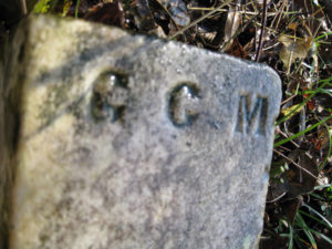 A stone slab with the initials gc m on it.